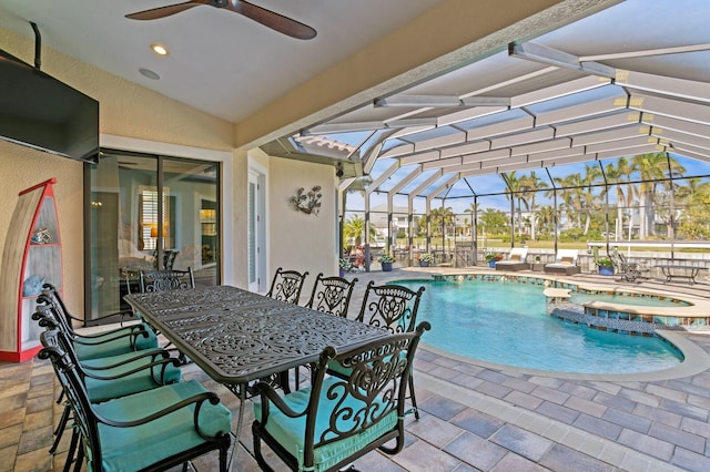 view of pool with an in ground hot tub, a lanai, and a patio area