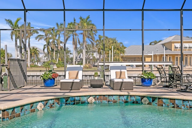 view of swimming pool with a patio area and glass enclosure