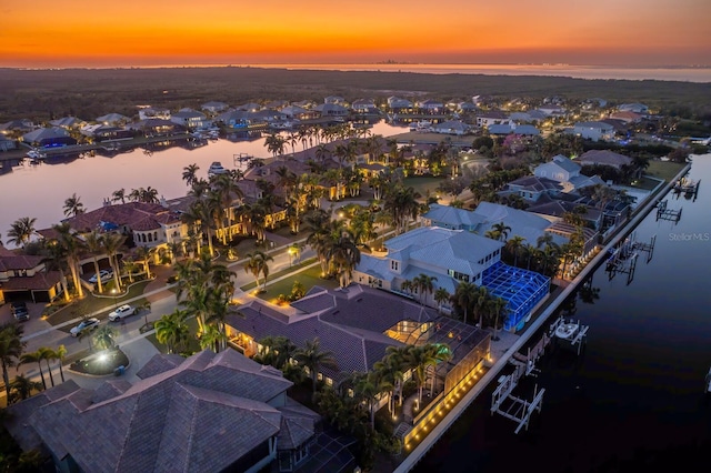 aerial view at dusk with a water view