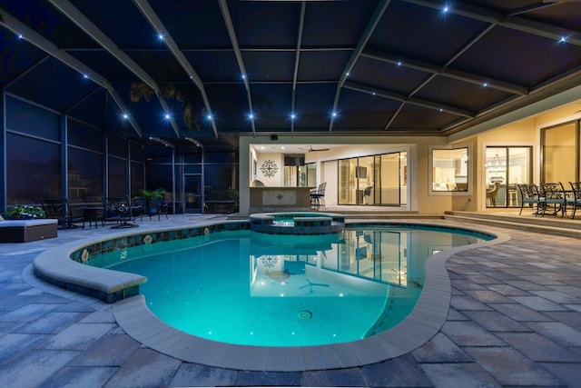 view of swimming pool with an in ground hot tub, a lanai, and a patio area