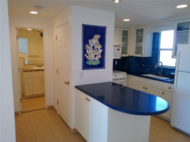 kitchen featuring white cabinetry, white appliances, sink, and decorative backsplash