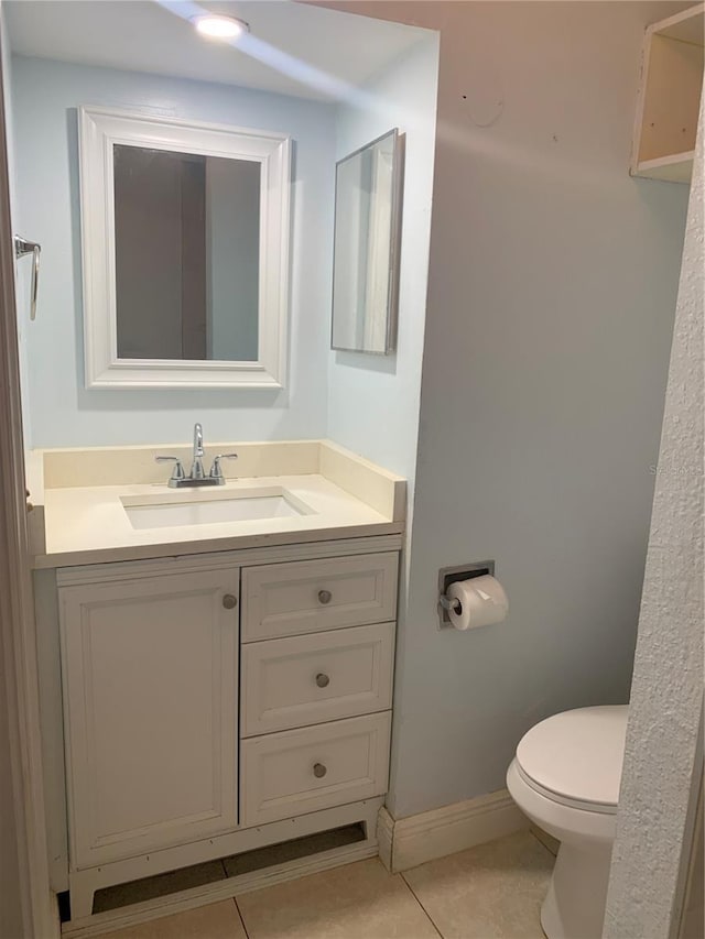 bathroom featuring vanity, tile patterned floors, and toilet