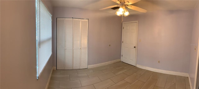 unfurnished bedroom featuring multiple windows, a closet, and ceiling fan