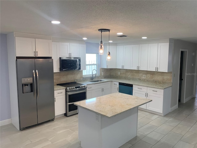 kitchen featuring sink, white cabinetry, hanging light fixtures, stainless steel appliances, and a center island