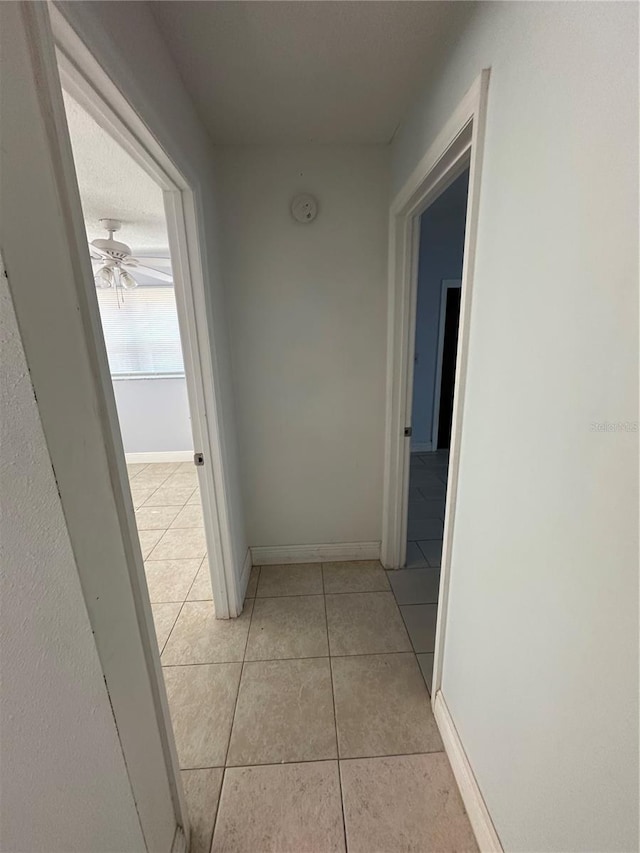 hallway featuring light tile patterned floors