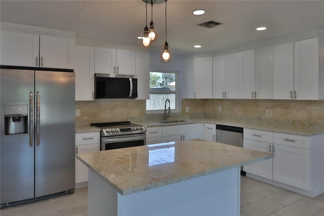 5729 13th St, Zephyrhills, FL 33542 - kitchen featuring appliances with stainless steel finishes, a sink, tasteful backsplash, light stone counters, and decorative light fixtures