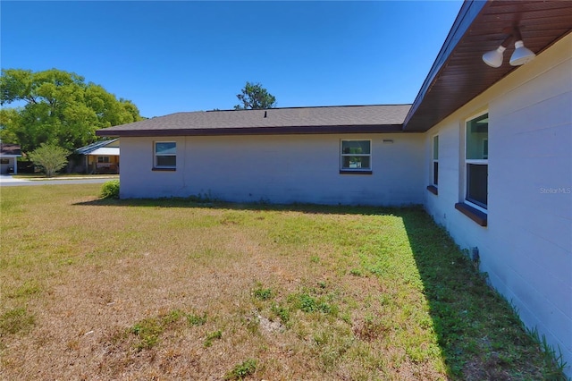 5729 13th St, Zephyrhills, FL 33542 - view of side of home with a yard