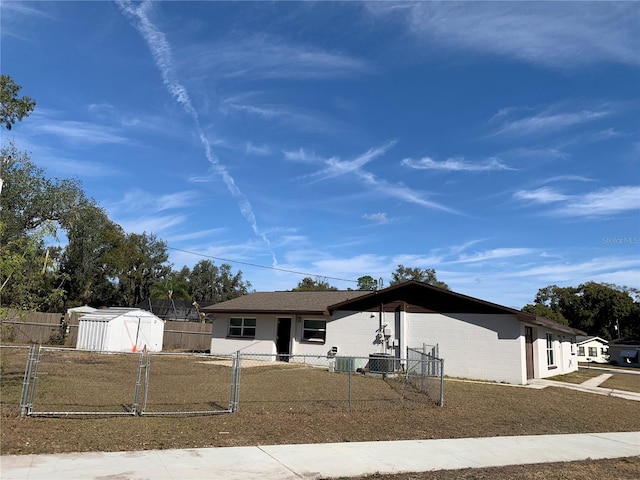 5729 13th St, Zephyrhills, FL 33542 - view of front of house featuring a storage shed and an outdoor structure