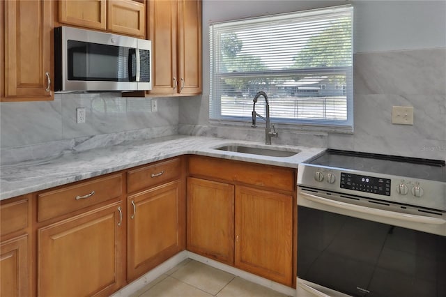 5729 13th St, Zephyrhills, FL 33542 - kitchen featuring stainless steel appliances, a sink, and brown cabinetry