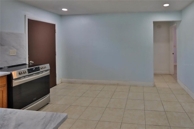 5729 13th St, Zephyrhills, FL 33542 - kitchen featuring electric range, recessed lighting, light tile patterned floors, light countertops, and baseboards
