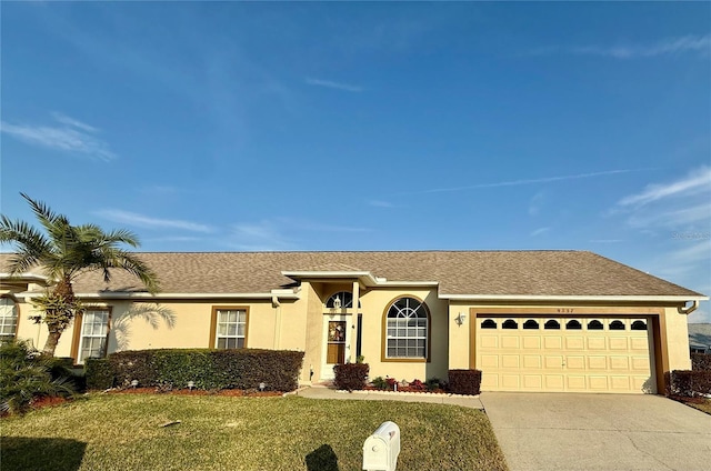 ranch-style house with a garage and a front lawn