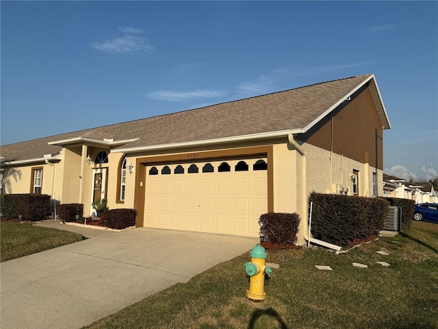 ranch-style house with a garage and a front lawn