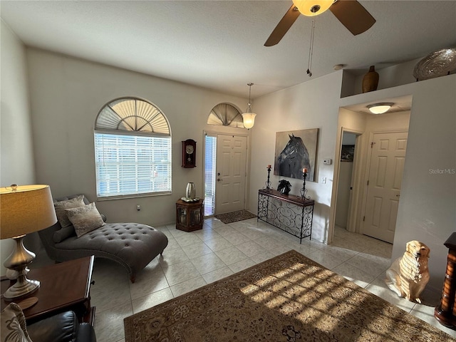 tiled foyer with ceiling fan