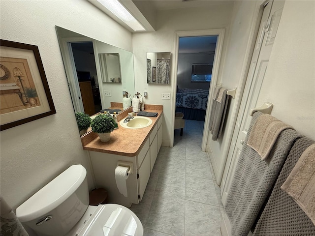 bathroom with vanity, tile patterned flooring, and toilet