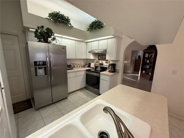 kitchen featuring white cabinetry, appliances with stainless steel finishes, sink, and light tile patterned floors