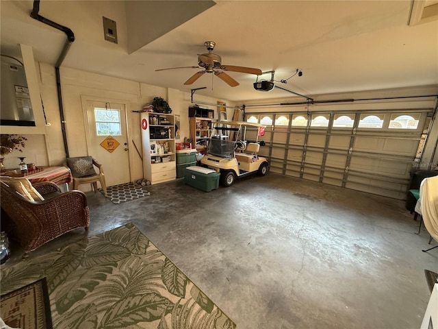 garage with ceiling fan and a garage door opener