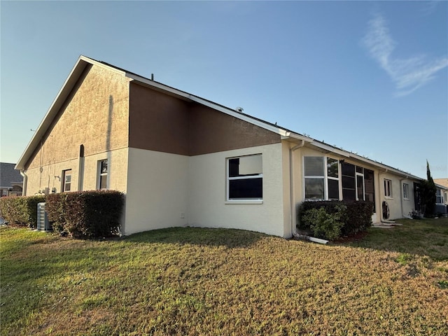 view of home's exterior with a lawn