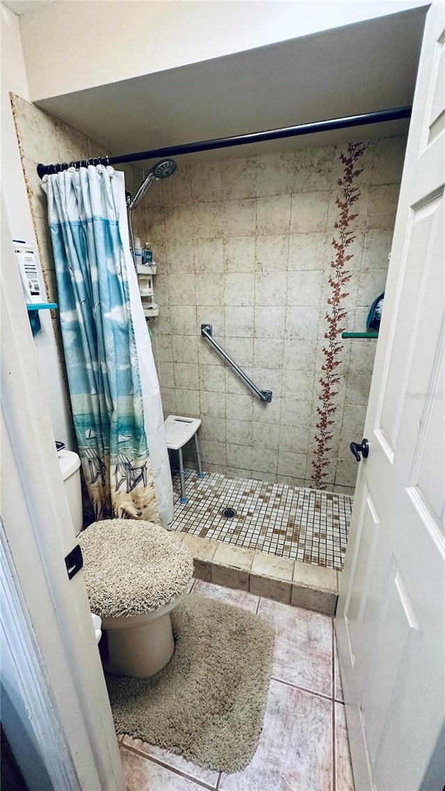 bathroom with walk in shower and toilet