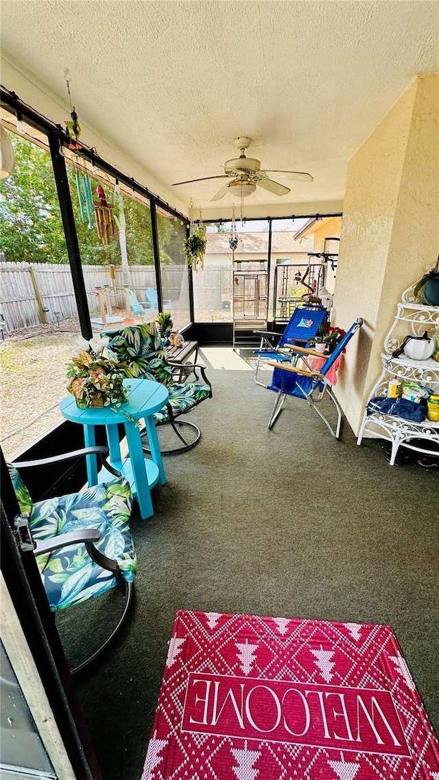 sunroom / solarium featuring ceiling fan