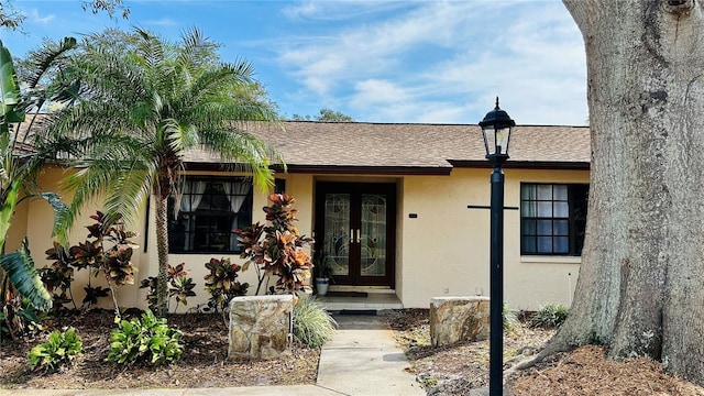 1670 Monterey Dr, Clearwater, FL 33756 - property entrance featuring french doors, stucco siding, and a shingled roof