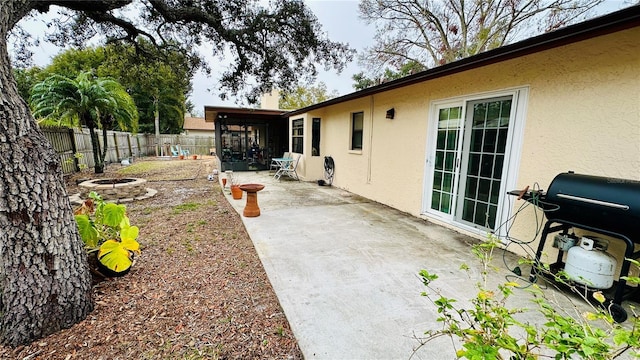 1670 Monterey Dr, Clearwater, FL 33756 - fenced backyard featuring a fire pit, a patio, and a sunroom