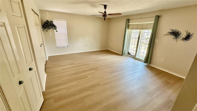 1670 Monterey Dr, Clearwater, FL 33756 - spare room with ceiling fan, wood finished floors, a textured ceiling, and baseboards