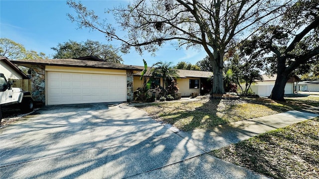 1670 Monterey Dr, Clearwater, FL 33756 - ranch-style house with driveway, an attached garage, fence, stucco siding, and stone siding