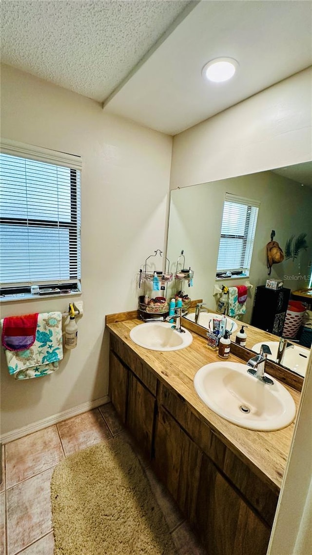 1670 Monterey Dr, Clearwater, FL 33756 - full bath featuring double vanity, tile patterned floors, and a textured ceiling