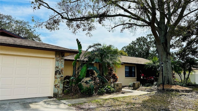1670 Monterey Dr, Clearwater, FL 33756 - view of front facade with an attached garage and stucco siding