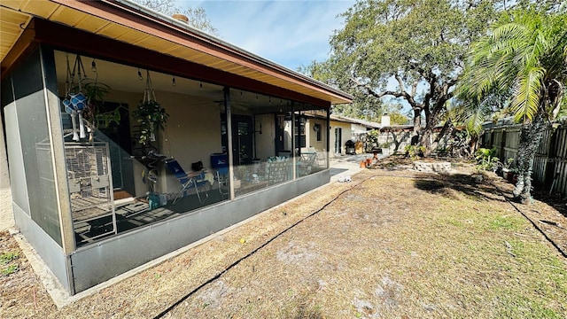 1670 Monterey Dr, Clearwater, FL 33756 - fenced backyard with ceiling fan and a sunroom