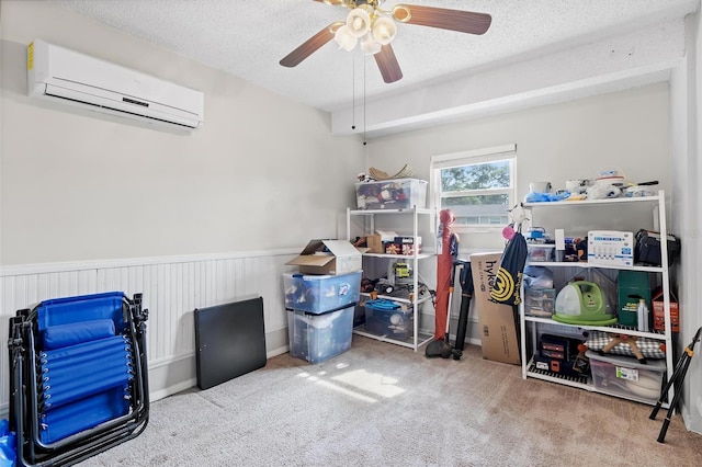 storage area with a wall unit AC and ceiling fan