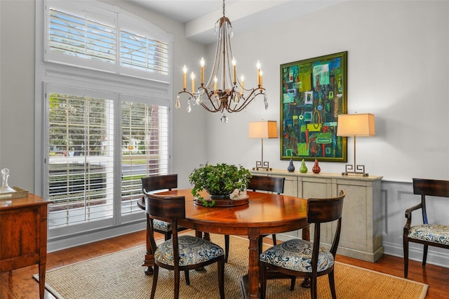 dining room featuring hardwood / wood-style flooring and a chandelier