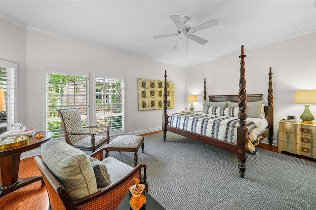 bedroom featuring hardwood / wood-style flooring, ornamental molding, and ceiling fan