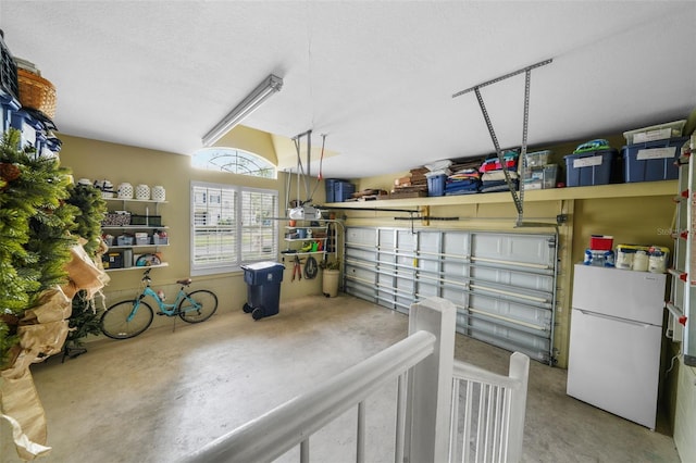 garage featuring white fridge