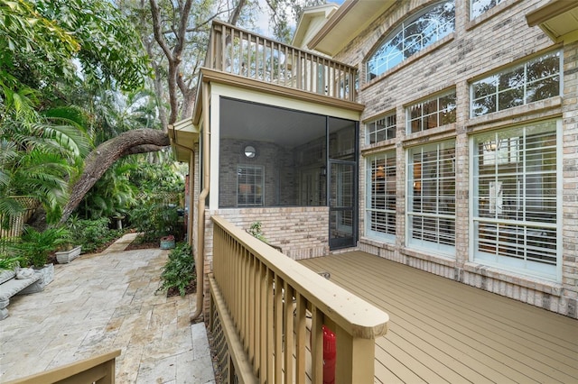 wooden deck with a sunroom