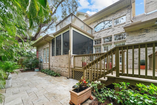 exterior space featuring a sunroom and a patio