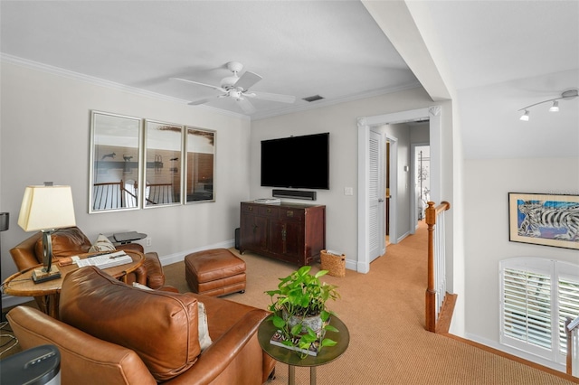 living room with ornamental molding, light colored carpet, and ceiling fan