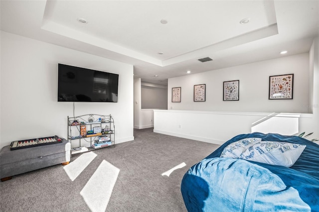 carpeted living room featuring a tray ceiling