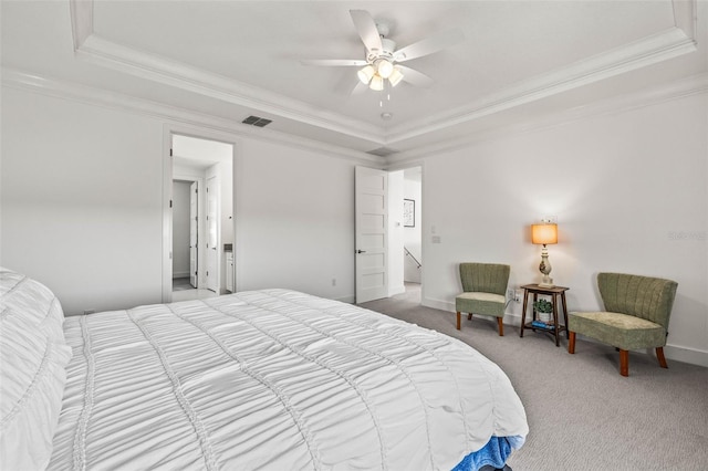 bedroom with a raised ceiling, ornamental molding, and carpet floors