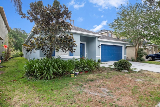 view of front facade with a garage and a front lawn