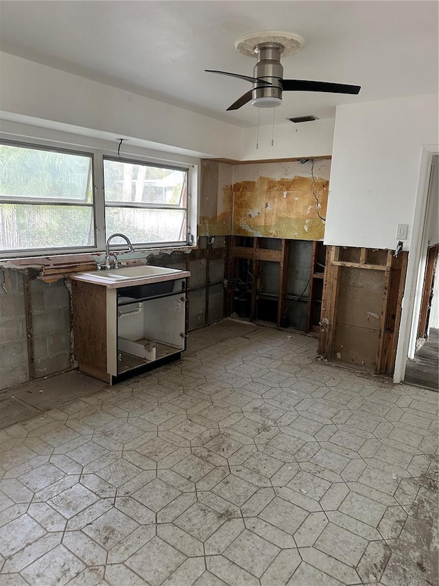 kitchen featuring sink, dark brown cabinets, and ceiling fan