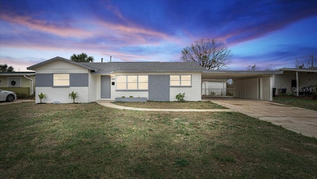 ranch-style home with a carport and a lawn