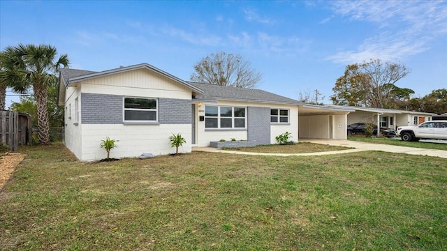 single story home featuring a front lawn and a carport