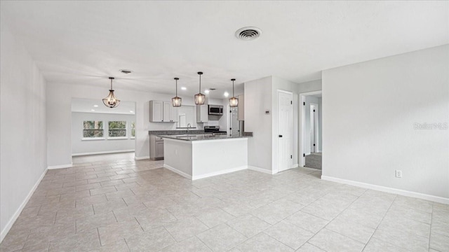 kitchen with hanging light fixtures, appliances with stainless steel finishes, and sink