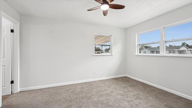 carpeted empty room featuring ceiling fan