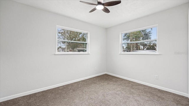 spare room with ceiling fan, a healthy amount of sunlight, and carpet