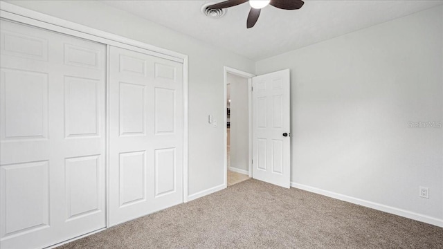 unfurnished bedroom featuring carpet floors, a closet, and ceiling fan