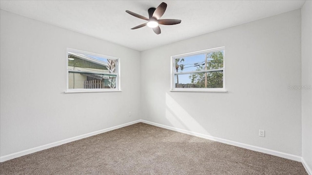 carpeted spare room with ceiling fan