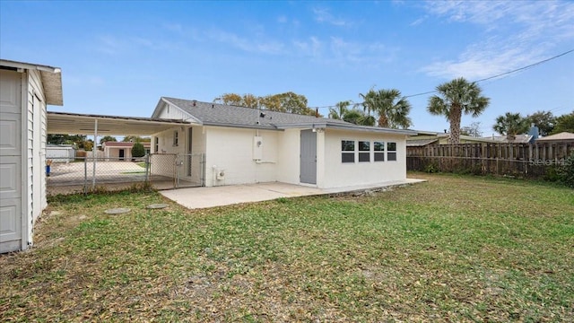 back of house featuring a yard and a patio