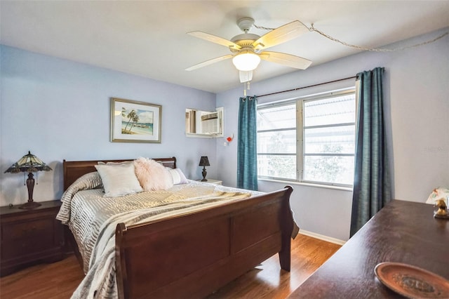 bedroom with wood-type flooring, a wall unit AC, and ceiling fan